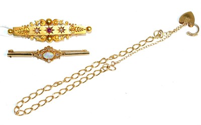 Lot 410 - A 15 carat gold ruby and diamond brooch, a star set ruby spaced by two old cut diamonds, to a...