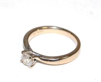 Lot 420 - An 18 carat white gold solitaire diamond ring, a round brilliant cut diamond in a claw setting...