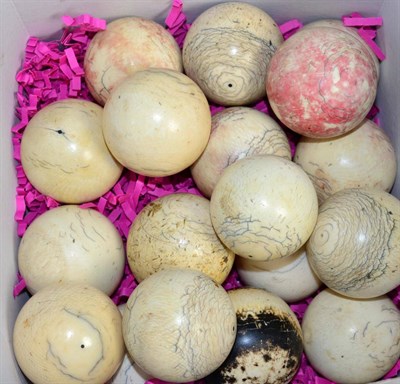 Lot 479 - A group of eighteen 19th century ivory billiard balls, some with traces of colour