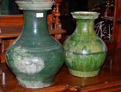 Lot 486 - Two Chinese Han dynasty style green glazed Hu vases bearing old Christie's labels