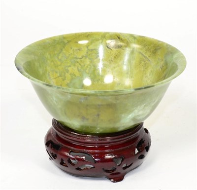 Lot 511 - A Chinese spinach jade bowl, 20th century, 12.5 diameter, on wooden stand