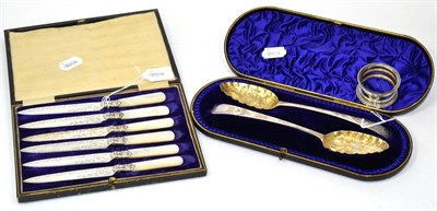 Lot 521 - A pair of George III spoons, London, 1785, later embossed, cased; together with a set of mother...