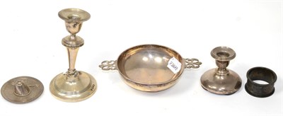 Lot 523 - A silver shallow bowl; two dwarf silver candlesticks; a silver napkin ring and a white metal...