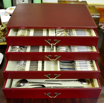 Lot 525 - A French silver plated twelve place setting table service in a maroon leather canteen