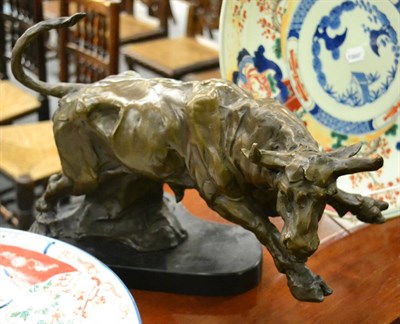 Lot 527 - A large cast bronze figure of a bull, stone base