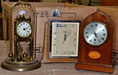 Lot 1002 - A mahogany lancet timepiece, a Smiths electric timepiece and a Torsion anniversary clock under dome