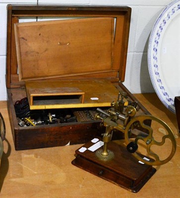 Lot 1053 - A watchmakers lathe with collets, contained in a wooden case, and a watchmakers hand cutting...