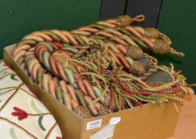 Lot 1069 - Three pairs of green, terracotta, green and beige tassled curtain tie backs; together with...