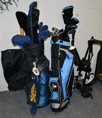 Lot 1079 - Two sets of golf clubs, one with trolley