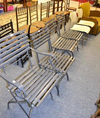 Lot 1175 - A set of four grey painted wooden slatted folding garden chairs and a rocking chair