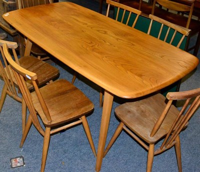 Lot 1192 - An Ercol light elm dining table