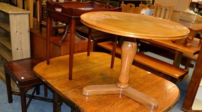 Lot 1195 - A reproduction circular walnut coffee table, a reproduction mahogany side table fitted a drawer and