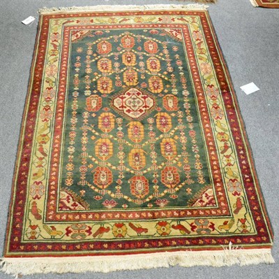 Lot 1232 - Kkila Rug, East Caucasus, the moss green field of boteh enclosed by ivory borders, 160cm by 102cm