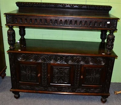 Lot 1247 - A carved oak buffet