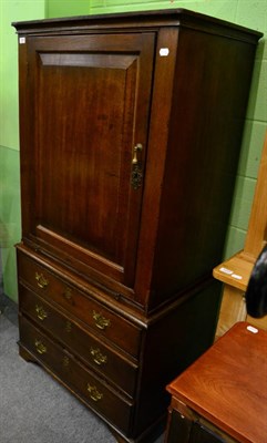 Lot 1248 - A George III oak cupboard on associated chest, the upper section with single door opening to reveal