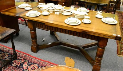 Lot 1263 - A reproduction oak draw-leaf dining table, labelled Chapmans & Co, Siesta House, Newcastle upon...