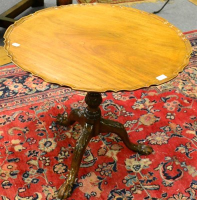 Lot 1269 - A 19th century mahogany tilt top tripod table, with pie crust top and ball and claw feet