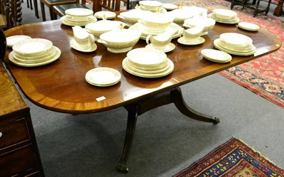 Lot 1270 - A 19th century cross banded mahogany pedestal dining table, raised on a reeded twist stem and...