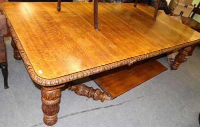 Lot 1296 - A large Victorian oak wind out dining table with additional leaves