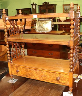 Lot 1300 - A leather inset walnut three tier whatnot fitted with base drawer