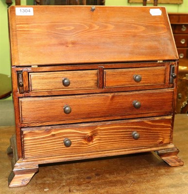 Lot 1304 - A miniature oak bureau