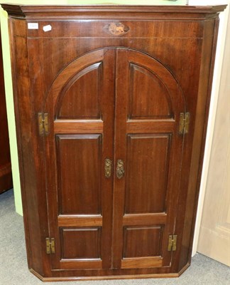 Lot 1324 - A 19th century panelled mahogany corner cupboard