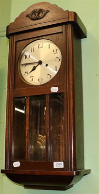 Lot 1325 - An Art Deco oak striking wall clock