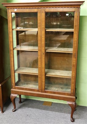 Lot 1331 - A well made glazed mahogany display cabinet with dentiled cornice, shell carved legs and pad...