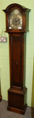 Lot 1338 - A 1930s oak chiming small longcase clock, chiming on gong rods