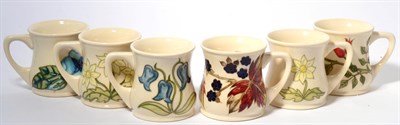 Lot 53 - A Moorcroft pottery Blackberry mug (silver line) designed by Sally Tuffin; a Moorcroft pottery...