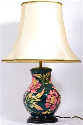 Lot 64 - A Moorcroft table lamp decorated witrh pink flowers on a green ground, 28cm (excluding fitting)