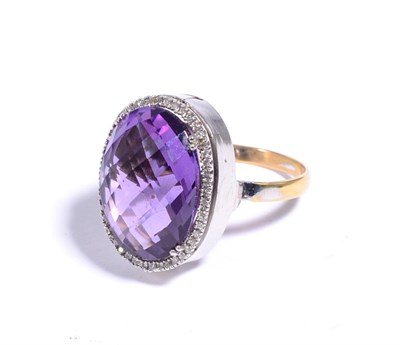 Lot 86 - An amethyst and diamond cluster ring, an oval checkerboard cut amethyst in a claw setting, within a