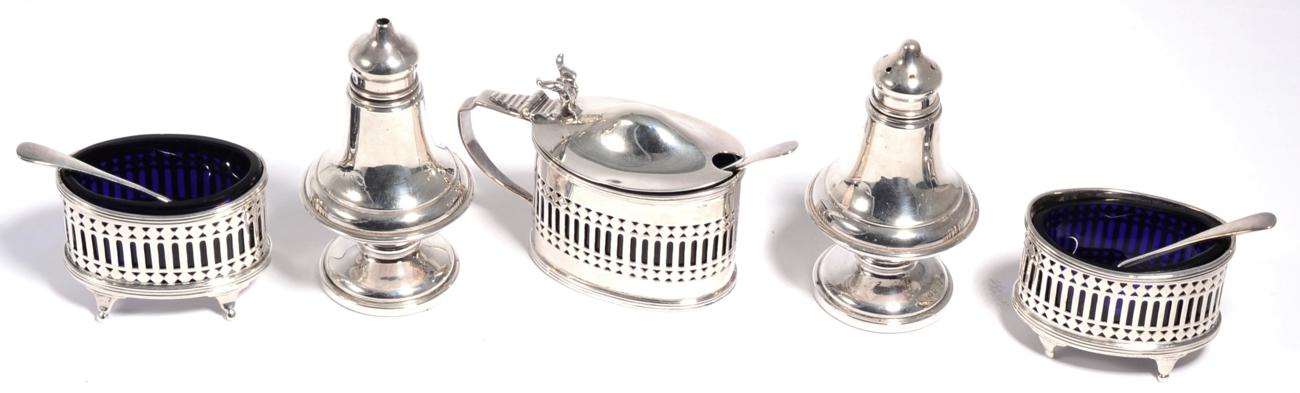 Lot 91 - A Georgian style lidded mustard pot and two salts, Chester, 1921-1923, with three spoons of navette