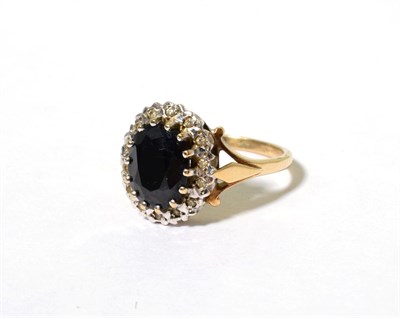 Lot 112 - A 9 carat gold sapphire and diamond cluster ring, an oval cut sapphire in a claw setting,...