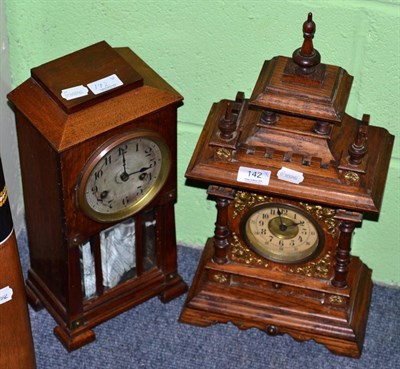Lot 142 - A 19th century oak cased striking mantle clock, together with an early 20th century example