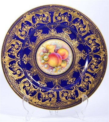 Lot 167 - A Royal Worcester fruit painted plate with blue and gilt border signed C Hughes, 27cms