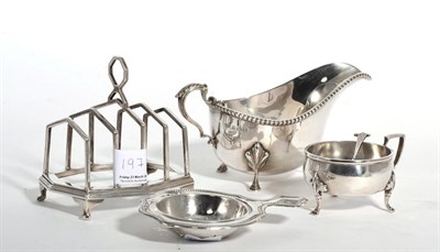 Lot 197 - Four pieces of Walker & Hall silver comprising: toast rack, sauceboat, salt and tea strainer (4)