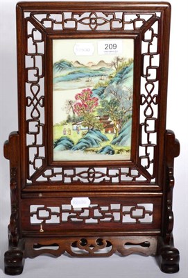 Lot 209 - A Chinese porcelain famille rose table screen with a pierced hardwood frame