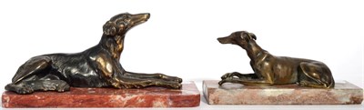 Lot 243 - An Art Deco recumbent spelter model of a Borzoi on a marble base, together with a similar model...