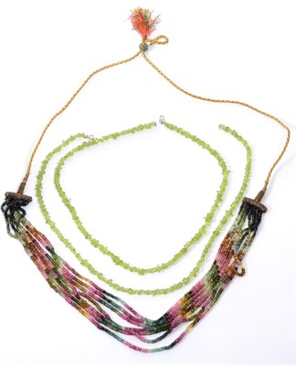 Lot 262 - A multi-gemstone bead necklace, seven graduated strands of faceted vari-coloured beads in tones...