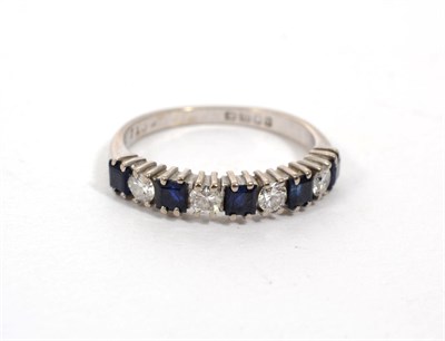 Lot 297 - An 18 carat white gold sapphire and diamond half hoop ring, total estimated diamond weight 0.20...