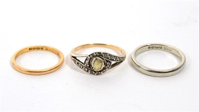 Lot 300 - An 18 carat white gold band ring, finger size K; a 22 carat gold band ring, finger size H; and...