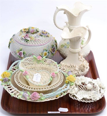 Lot 329 - Three Belleek basket form dishes, two Belleek jugs, a Dresden floral encrusted jar and cover...