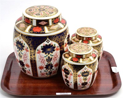 Lot 334 - A Royal Crown Derby Imari ginger jar and cover; and a smaller matching pair (3)