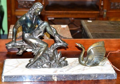 Lot 369 - An Art Deco patinated metal figure with swan, on a stepped marble base