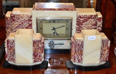 Lot 378 - An Art Deco marble, slate and alabaster mantel timepiece with garniture