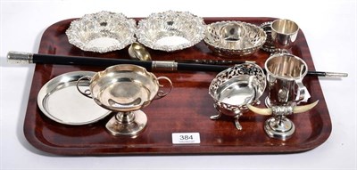 Lot 384 - A group of silver items to include: an ebonised baton; two pairs of bon bon dishes; small mug;...