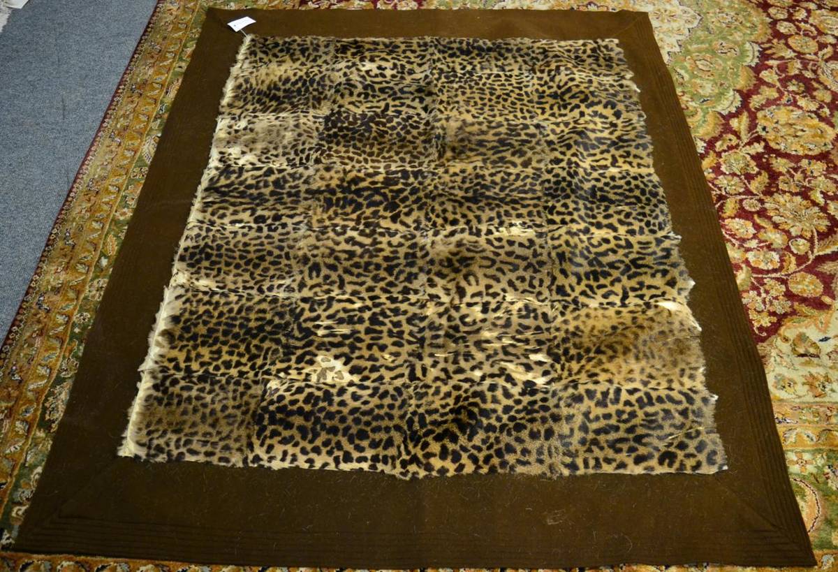 Lot 1013 - Taxidermy: Simulated Leopard Skin Carriage Rug, circa 1930, a patchwork carriage rug made from...