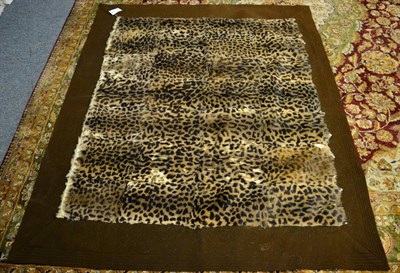 Lot 1013 - Taxidermy: Simulated Leopard Skin Carriage Rug, circa 1930, a patchwork carriage rug made from...