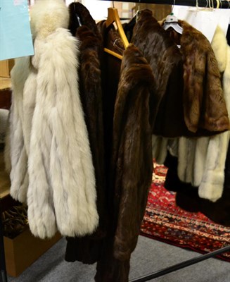 Lot 1035 - Saga Furs white fox fur ribbed jacket size S, long brown squirrel fur coat and a similar...